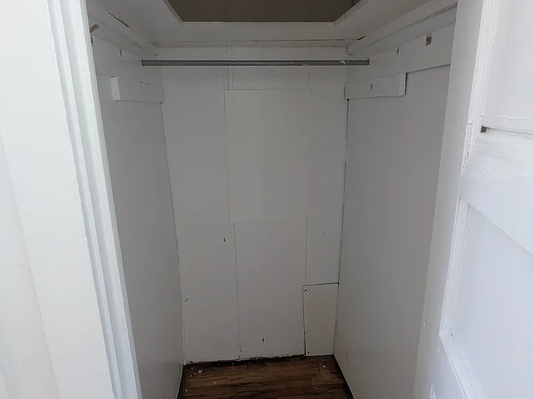 Large walk-in closet for clothing, storage or maybe a kitchen pantry