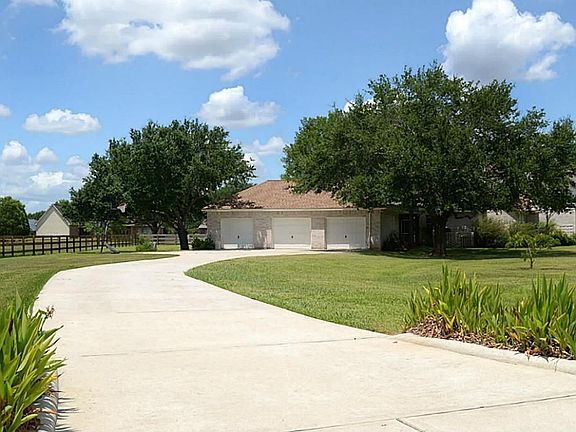 A separate drive leads to the oversized 3-car detached Garage with individual doors.  The home has community water, yet it also offers a separate water well for irrigation