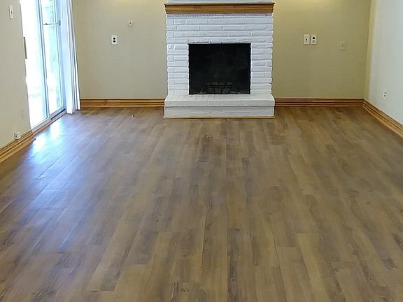 Primary Living room with wood burning fireplace and patio door