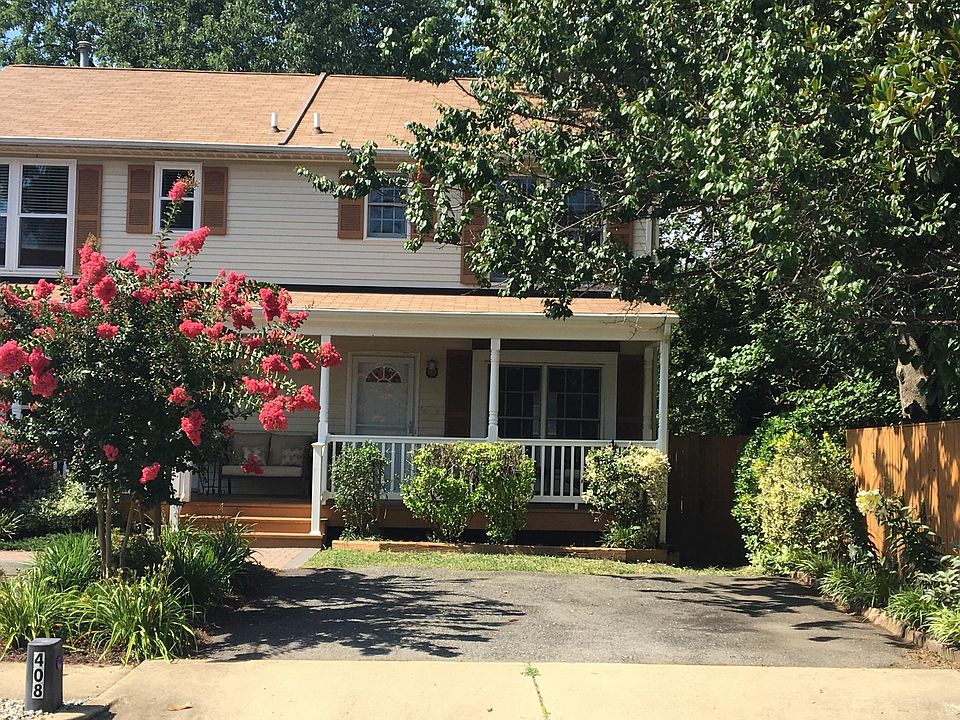Right side of duplex home with two off-street parking spaces in driveway.