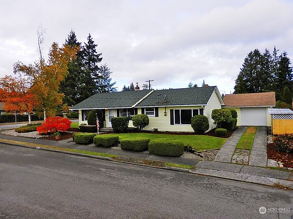 Detached garage and a covered firewood shed>