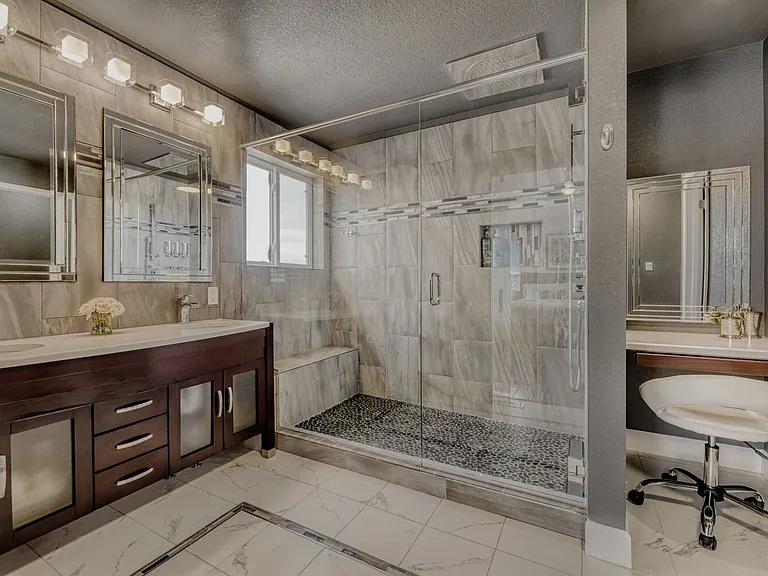 Huge rain shower in primary bath with primp station for make up. Double sinks