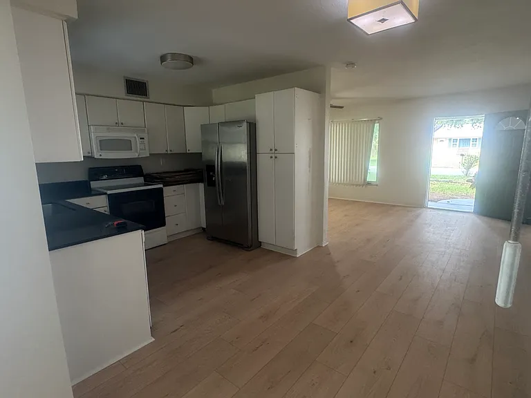 view of dining area, kitchen, open into living room
