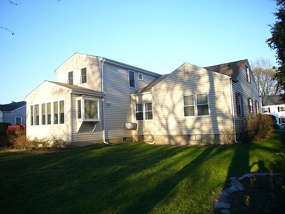 The rear view of this home details the large addition.