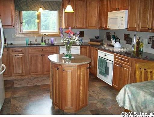 BRAND NEW custom kitchen with rich cherry cabinets and stone countertops.