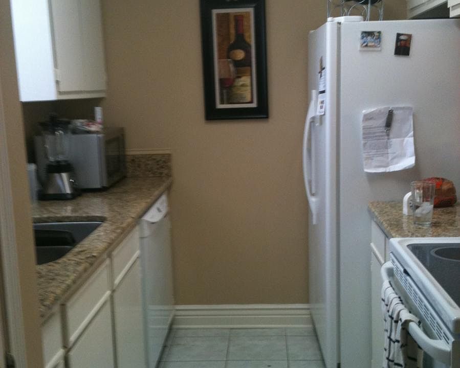 kitchen with granite counter-tops, oven, fridge, micro-wave,