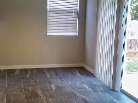 Living room to dining room and sliding glass door to backyar