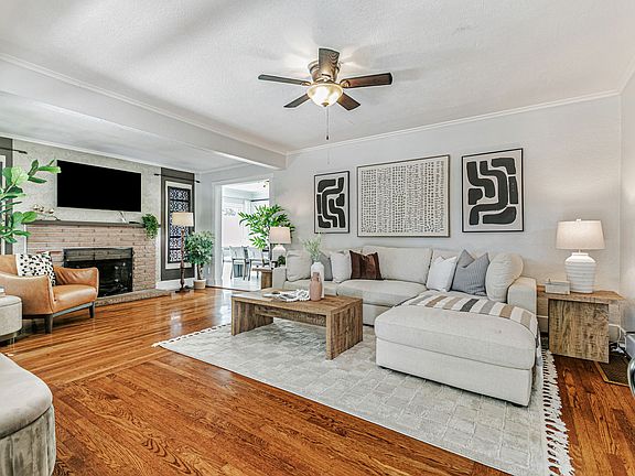 Spacious living room with ceiling fan, central AC and an easy flow into the kitchen dining spaces.