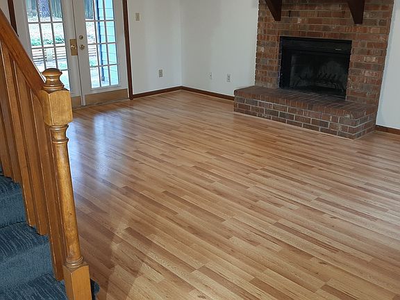 Living room with fireplace and French doors leading to fenced in back yard