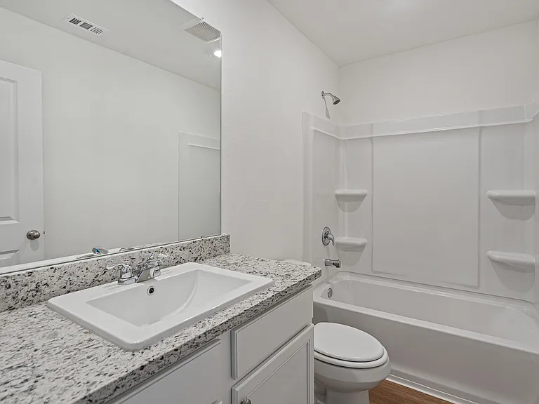 Second bathroom with a shower/tub combination.