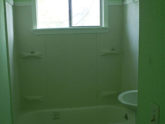 Remodeled bath, new tub, vanity, floor, toilet and lighting (pale green)