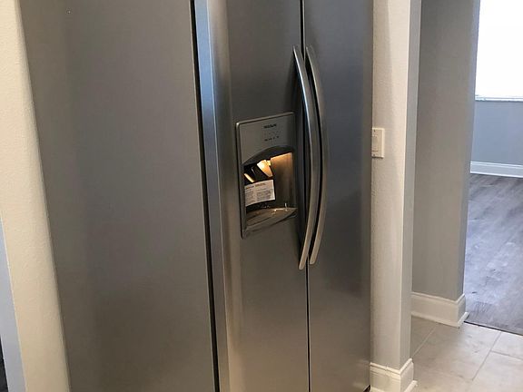 side by side stainless frig with ice maker and water
