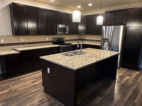 Large entertaining kitchen also has a desk and tons of cabinet space