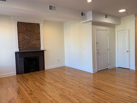 Apartment entry into open concept living room, dining and kitchen