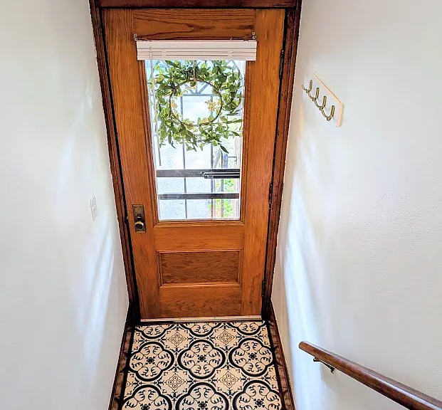 [UPPER UNIT]: front entryway with new laminate flooring and coat hook rack