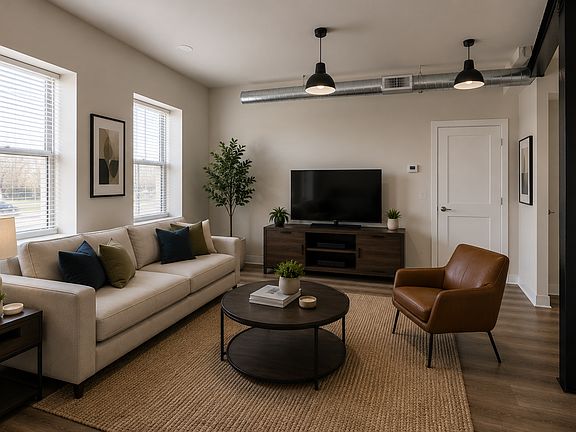 Spacious living area with industrial loft details, waterproof flooring, and exposed ductwork.