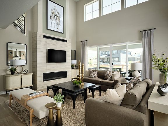 A spacious and well-designed living room with a large sofa, coffee table, and various decorative ele