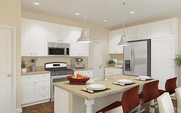 Plan 1 Kitchen with island, breakfast bar and stainless steel appliances