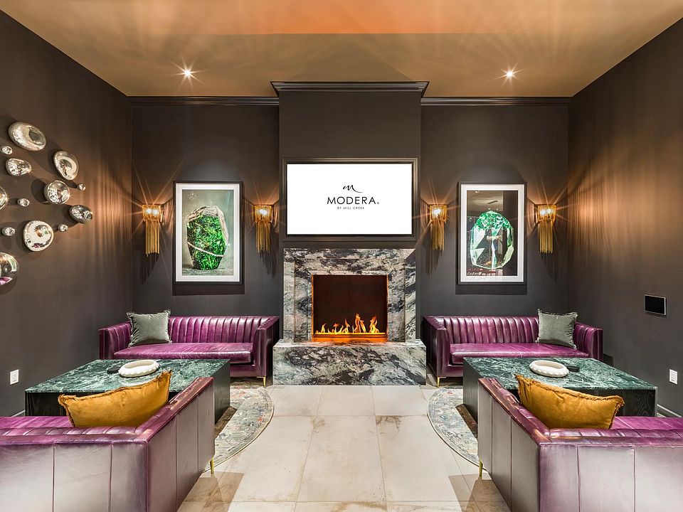 Cozy up by the fireplace in a stylish lounge designed for both comfort and connection at Modera Argyle.