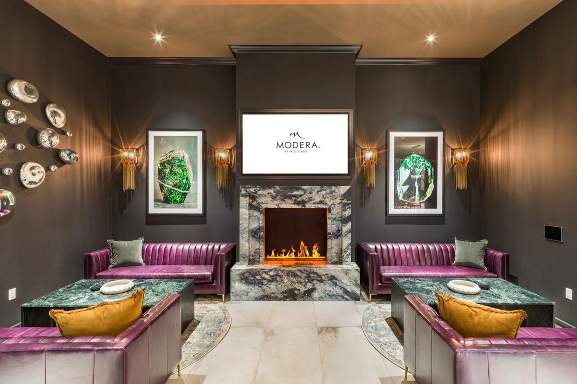 Cozy up by the fireplace in a stylish lounge designed for both comfort and connection at Modera Argyle.