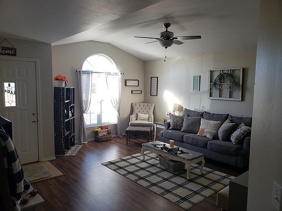 living room, cathedral window, knock-down ceiling texture, tile entryway.