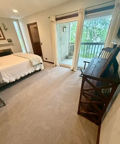Second Story Primary Bedroom with Queen Plus Bed, Walk-In Closet, balcony and Gas Fireplace.