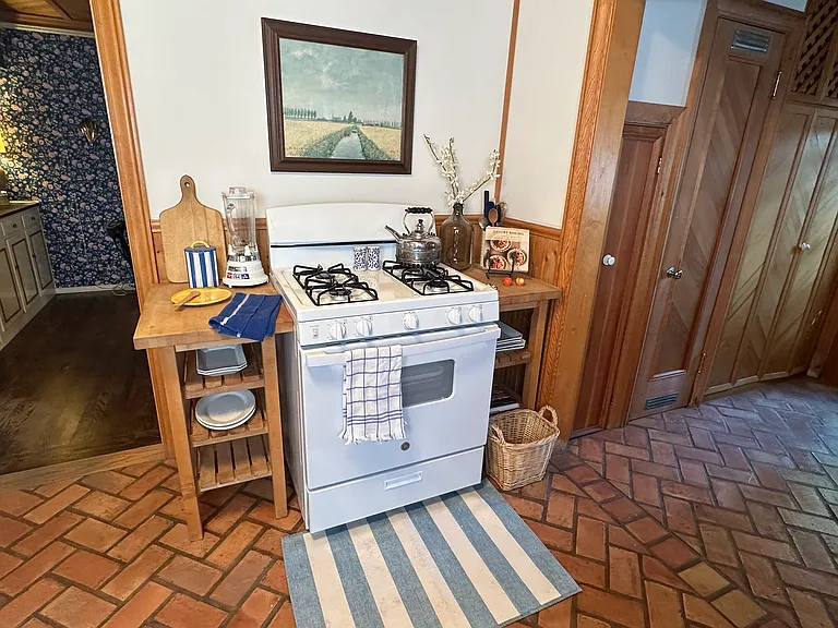 Kitchen complete with baking and cooking utensils, dishware and hosting supplies, ample storage