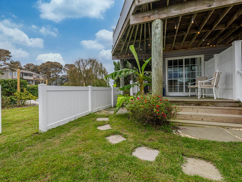 Sliding Door Entrance to Beach Bay Getaway. Private Deck and Courtyard. Gate to access to dock and canal for SUP, Kayak, Fishing, etc.