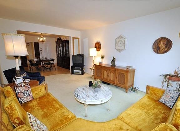 The large sunny living room opens to the large dining foyer.