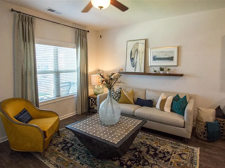 Living room with large couch and windows.