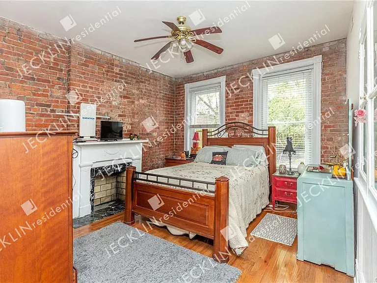 Bedroom with Fireplace and Exposed Brick