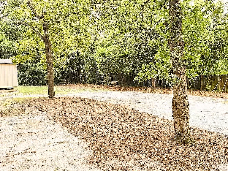 Large yard with storage shed.