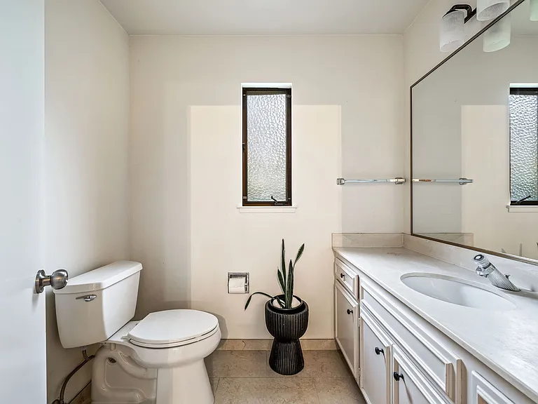 Secondary 1/2 bath on lower floor is a shared bathroom.