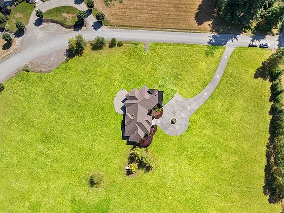 Aerial view of home and acreage.