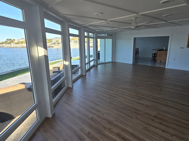 2nd living room looking towards Kitchen and Dining area. Floor to ceiling water views.