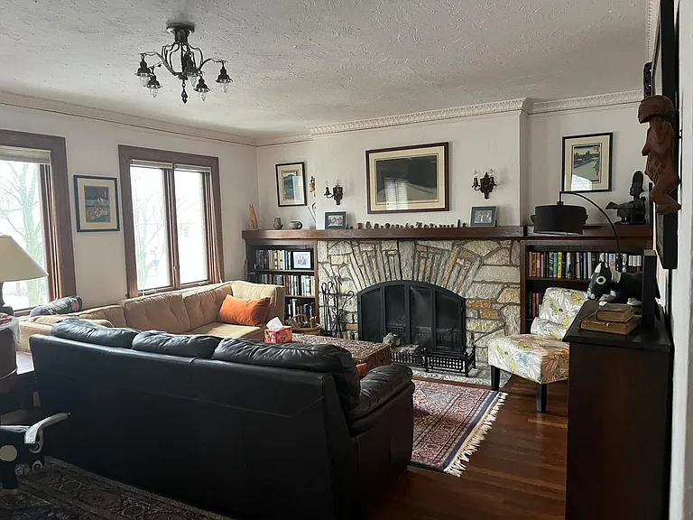 Large living room with decorative fireplace and built-ins. There is another 8+ feet behind this couch to the sunroom.