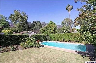 #3 View of backyard showing rose garden, lawn and pool with mountain views