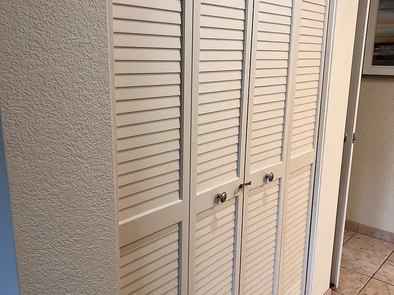 Hallway closets for ample storage. Vaccum cleaner, stool, Iron and ironing board, broom and dust pan, stored here.