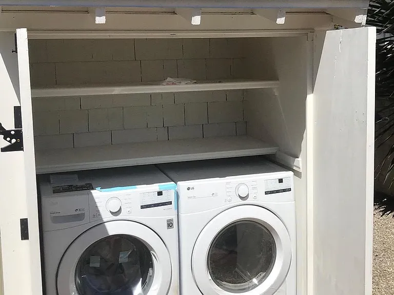 New washer and dryer for this unit only (not shared), with additional storage shelves above.