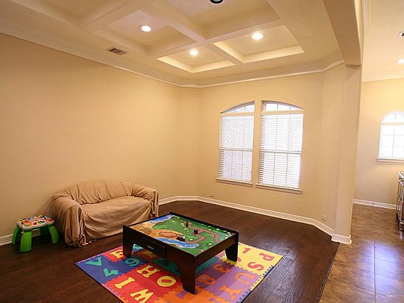 This is a beautiful Dining room that is currently being used for children's toys.