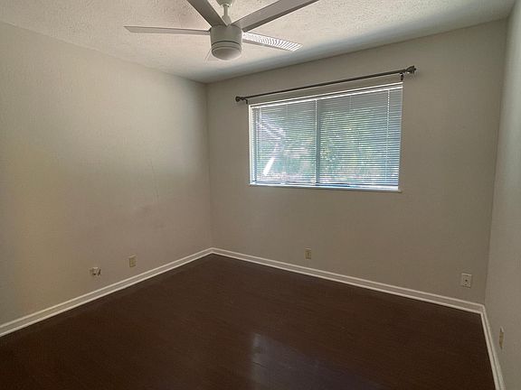 Bedroom 1 with brand new blinds and fan. *Not pictured - closet to the side
