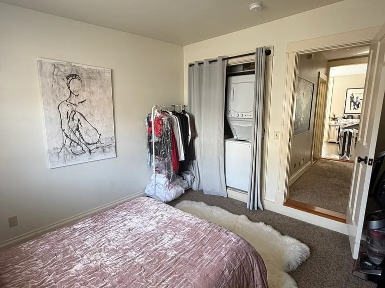 bedroom with view of washer/dryer in closet