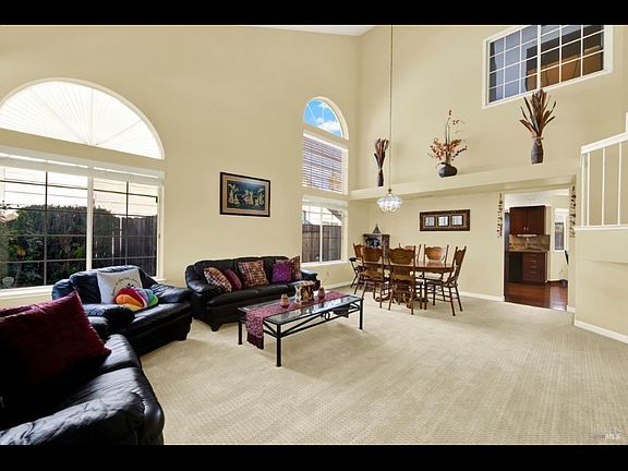 Main living room area with vaulted ceiling combined with formal dining room area
