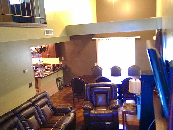 View from stairs overlooking living and dining rooms