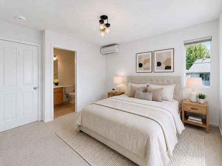 Master bedroom with ensuite bath, walk-in closet, and ductless heating and A/C