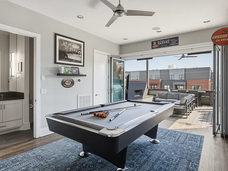 Upstairs game room connected to the rooftop patio and mini bar_an ideal hangout space for friendly competition and evening cocktails.