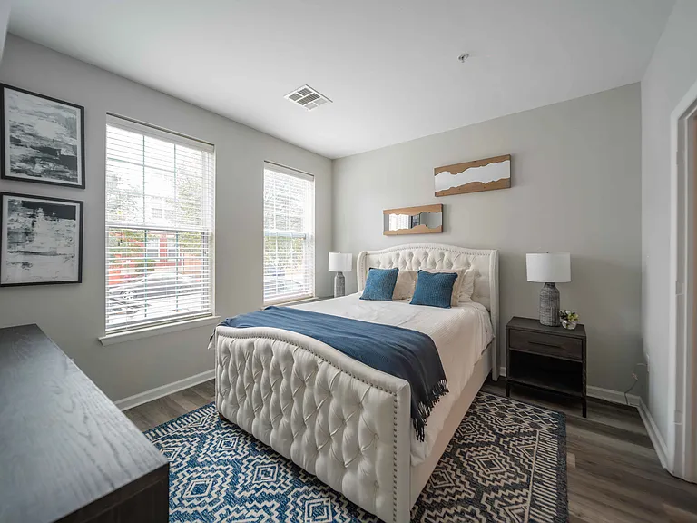 a bedroom with a large bed and two windows at Harbor Pointe, Bayonne, NJ, 07002
