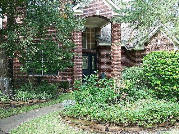 Inviting entry with lush landscaping.