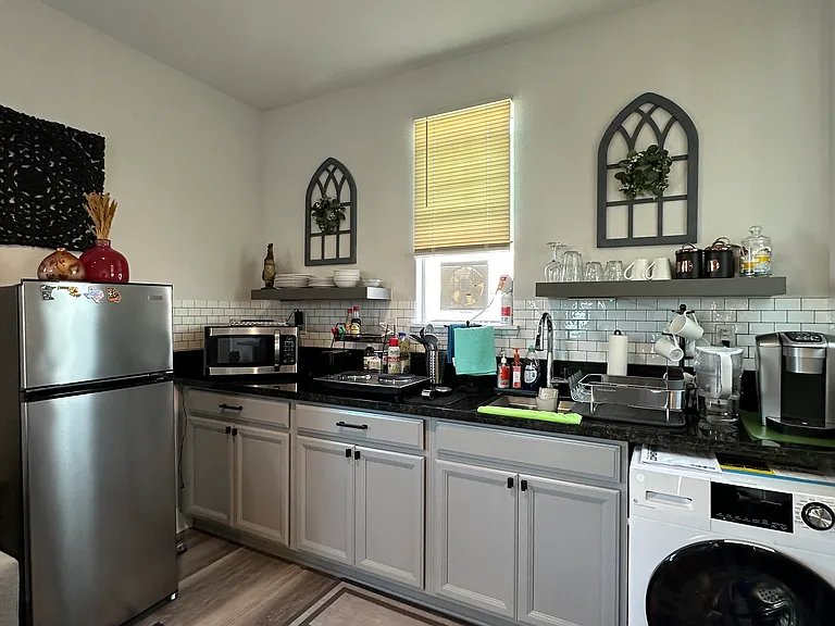 Microwave, convection stove, toaster, air fryer, pots and pans.