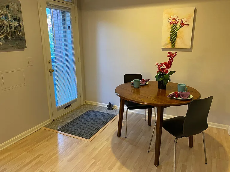 Dining seating for two. 
Large window in door plus 3 windows in alcove bring lots of light into the sitting room. 
This entrance to the apartment faces Maryland Ave.